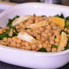 Colocar en una ensaladera la espinaca picada, los garbanzos, gajos de naranja y trocitos de queso de cabra.