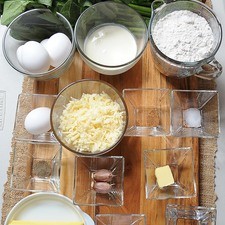 Ingredientes para la base: 125 gramos de mantequilla 1 pieza de huevo 2 tazas de harina de trigo 1 pizca de sal 1/4 taza de agua fría Ingredientes para relleno: 2 manojos de espinaca 1 cucharada de mantequilla 2 dientes de ajo 4 piezas de huevo 1/2 taza de crema para batir 1/4 cucharita de nuez moscada en polvo 1/4 cucharita de pimienta negra molida 1/4 cucharita de sal 1 taza de queso gruyere rallado