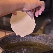 Calentar suficiente aceite en un sartén de 3 centímetros de profundidad. Comprobar que el aceite esté bien caliente, agregando una pizca de la masa.