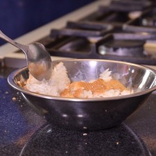 Para preparar la salsa, colocar en un tazón media taza de leche, desmenuzar el bolillo y dejar remojar durante 3 minutos.