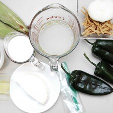 Ingredientes para receta 4 piezas de chile poblano 1/2 pieza de cebolla blanca 2 piezas de elote 1 taza de leche de vaca 1 taza de crema de leche de vaca 2 tazas de caldo de pollo 200 gramos de queso panela 1 cucharada de aceite de oliva sal al gusto pimienta negra molida al gusto tiras de tortillas fritas al gusto 1 pieza de bolsa de plástico