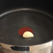 Pelar un diente de ajo, freír en una sartén con aceite hasta que se dore y luego retirarlo.