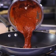 Tostar media tortilla licuar con los chiles, cebolla, ajo y moler hasta obtener una mezcla homogénea. Sofreír la salsa,