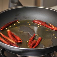 Quitar los rabos a los chiles de árbol y freír en una sartén a fuego medio con aceite de oliva un par de minutos.