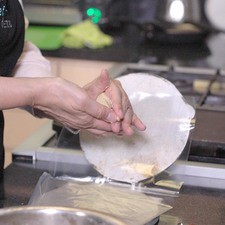 Tomar una bola de masa con la mano y formar una bolita. Hacer u hueco en la bolita de masa y añadir un poco de chicharrón prensado.