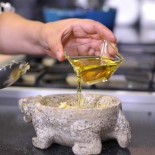 Colocar en el mortero los dientes de ajo y moler hasta obtener una mezcla martajada. Añadir un poquito de aceite y revolver bien .