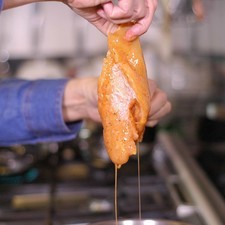 Pasar las pechugas por la mezcla de huevo batido y luego por el pan molido. Rs 1482331568