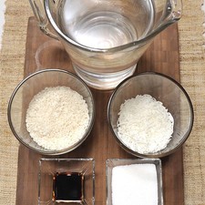 1 vara de Canela 1/4 de taza de Azúcar blanca Agua 1 cucharada de Extracto de vainilla 1/2 taza de Coco rallado 1/2 taza de Arroz