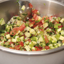 Picar finamente la cebolla, el cilantro, los jitomates guajes, el apio y la calabacita. Mezclar todo esto en un tazón con el cous cous pre cocido.
