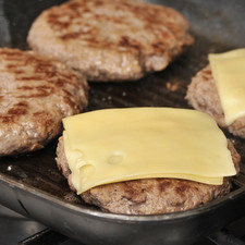Cocer cada carne por un lado hasta que suelte sangre por arriba. Voltearla con la pala y cocer por el otro lado. Darle una última vuelta para dejarla dorada y colocar una rebanada de queso encima para que se derrita.
