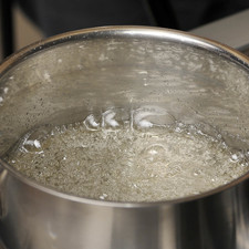 Mientras, preparar un almíbar hirviendo el azúcar con el tercio de taza de agua a punto de bola, o si se tiene un termómetro a 121°C.