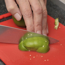 Picar finamente el ajo. Aparte picar la albahaca, hierbabuena y el perejil. Picar los tomates verdes en cubos pequeños.