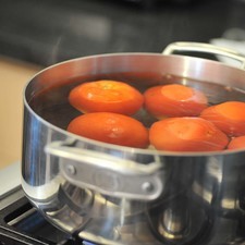 Poner suficiente agua a hervir a fuego alto en una olla honda y grande para cubrir los jitomates, cocer hasta que la cáscara se despelleje, aproximadamente 5 minutos.