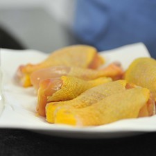 Lavar bien las piezas de pollo, secarlas con un trapo y revolcarlas en la mezcla. Picar la cebolla en rajas.