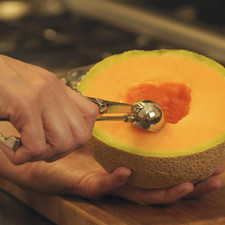 Con un cauchara, retirar las semillas del centro del melón. Con una cuchara pequeña para hacer bolas de helado, hacer bolitas de melón. También se puede cortar en cubos pequeños.