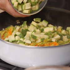 Añadir las flores de calabaza y las calabacitas picadas. Cocer meneando frecuentemente durante 5 minutos más. S 7415 1475622585