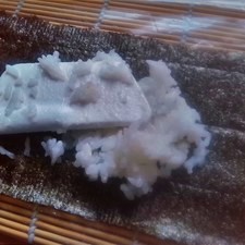 Con la pala miserable, distribuye el arroz en el nori.