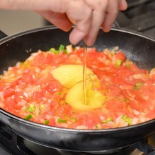 Agregar los huevos, sazonar con sal y continuar cociendo hasta que estén cocidos.