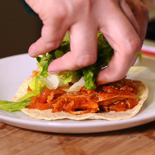 Colocar en cada tostada un poco de tinga, lechuga, rodajas de aguacate y una rebanada de queso.