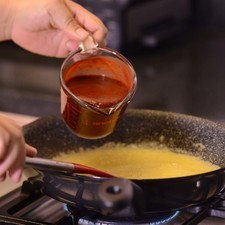 Añadir la salsa búfalo y mover constantemente un par de minutos, agregar la paprika, vinagre blanco continuar cociendo hasta que quede espesa. Dividir a la mitad y reservar.