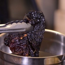 Enjuagar y poner a remojar los chiles en un tazón con un poco de sal, hasta que se ablanden, aproximadamente 30 minutos.